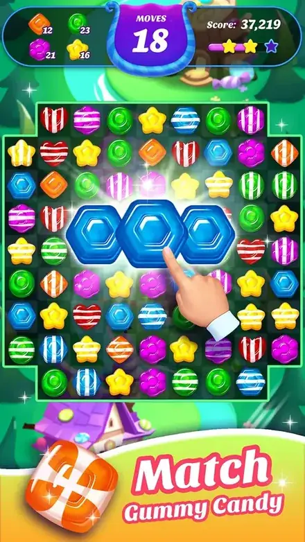 Gummy Candy Blast gameplay: a dense tray of glossy gummies with a finger about to swap two blue hexagons